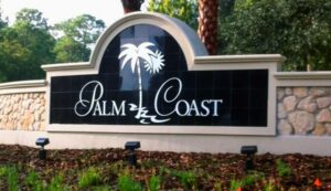 Palm Coast city welcome sign surrounded by greenery, symbolizing tranquility and healing.